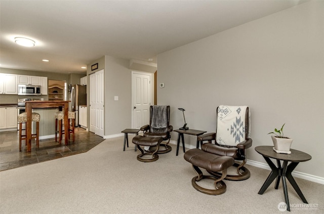 sitting room featuring recessed lighting, baseboards, and dark carpet