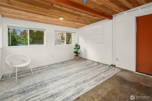 empty room featuring wooden ceiling, concrete floors, and vaulted ceiling