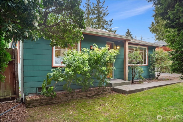 exterior space featuring a front yard and fence