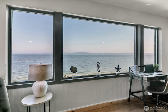 interior space featuring wood finished floors and a water view