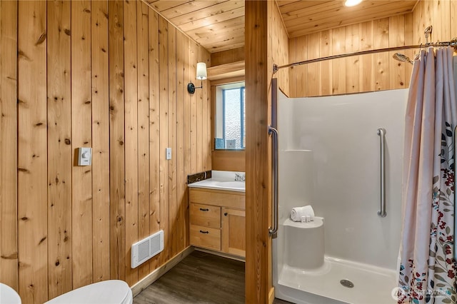 full bathroom featuring wooden walls, visible vents, a shower stall, wood ceiling, and toilet