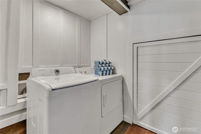 laundry room with washer and dryer, dark wood-type flooring, and laundry area