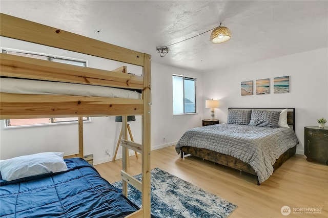 bedroom featuring baseboards and light wood-type flooring