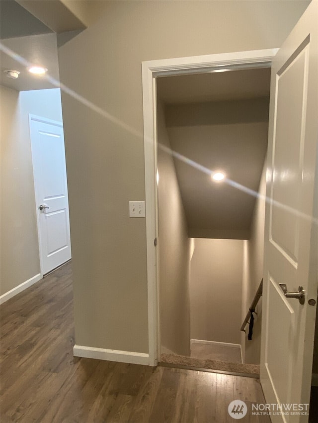 hall featuring baseboards and wood finished floors