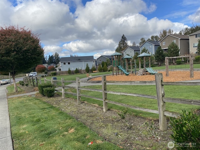 exterior space featuring a residential view, playground community, and fence