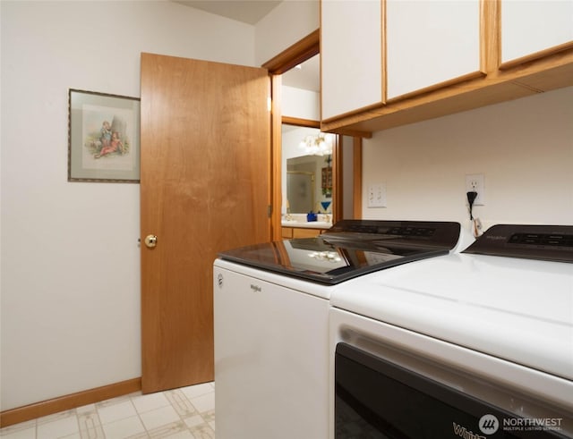 laundry area featuring light floors, cabinet space, washer and clothes dryer, and baseboards