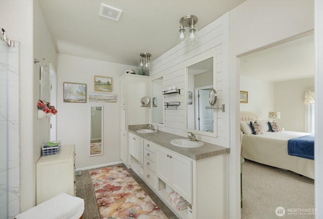 ensuite bathroom with double vanity, visible vents, a sink, and ensuite bathroom