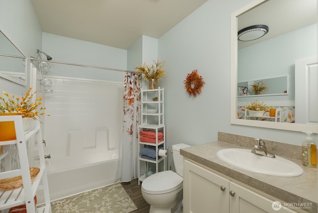 bathroom featuring toilet, wood finished floors, shower / tub combo with curtain, and vanity