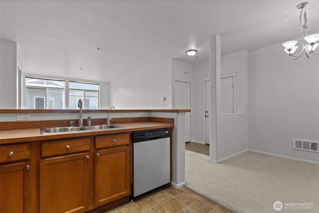 kitchen with visible vents, light colored carpet, brown cabinets, stainless steel dishwasher, and a sink