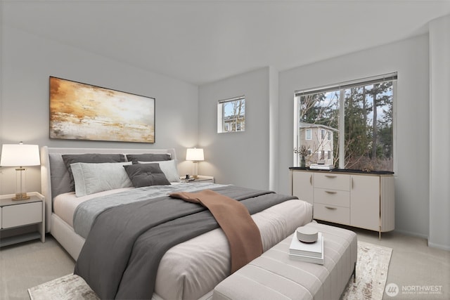 bedroom featuring baseboards and light colored carpet