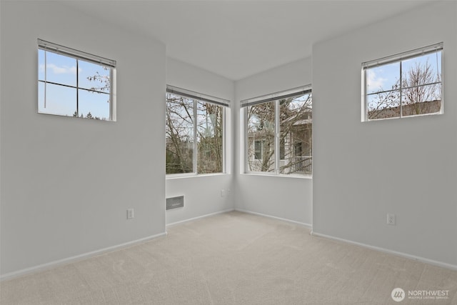 empty room with visible vents, baseboards, and carpet floors