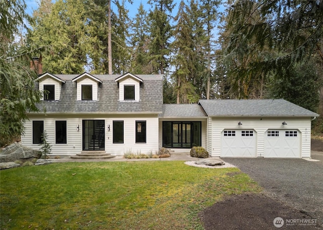 view of front of home featuring driveway, a front lawn, a garage, and roof with shingles