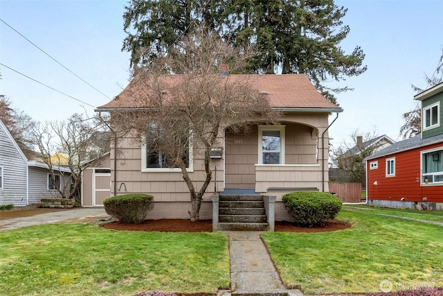 bungalow-style home with a front lawn