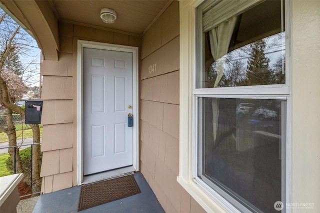 view of exterior entry featuring fence