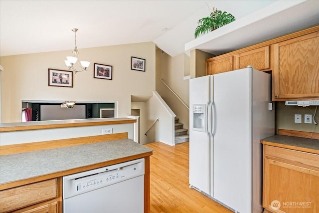 kitchen featuring pendant lighting, light wood-style flooring, white appliances, an inviting chandelier, and lofted ceiling