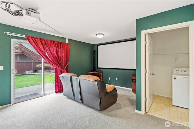 carpeted cinema featuring washer / clothes dryer and baseboards