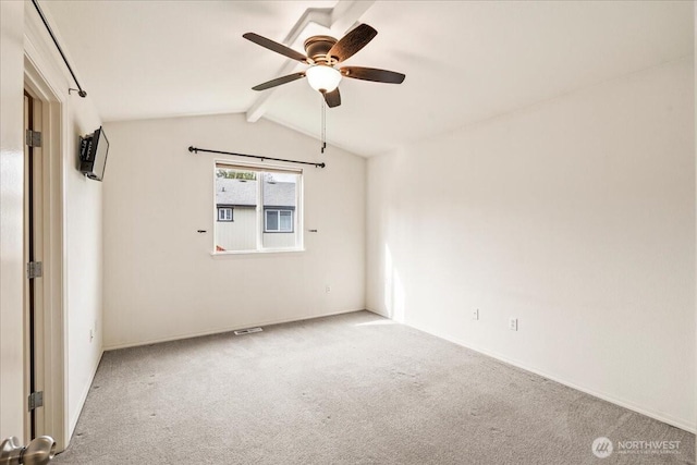 carpeted empty room with lofted ceiling with beams and a ceiling fan