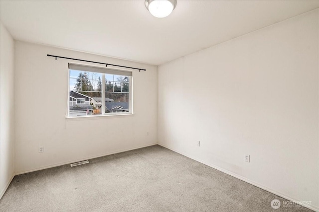 unfurnished room with baseboards, visible vents, and carpet floors