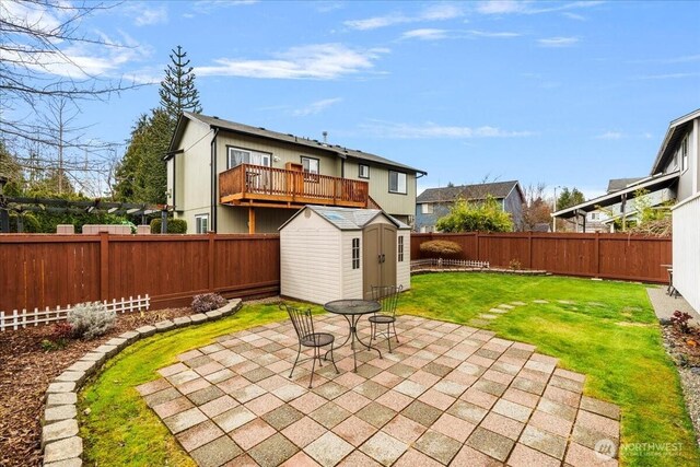 back of property featuring a lawn, a patio, a fenced backyard, a shed, and an outdoor structure