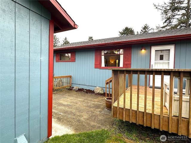 view of exterior entry with a deck