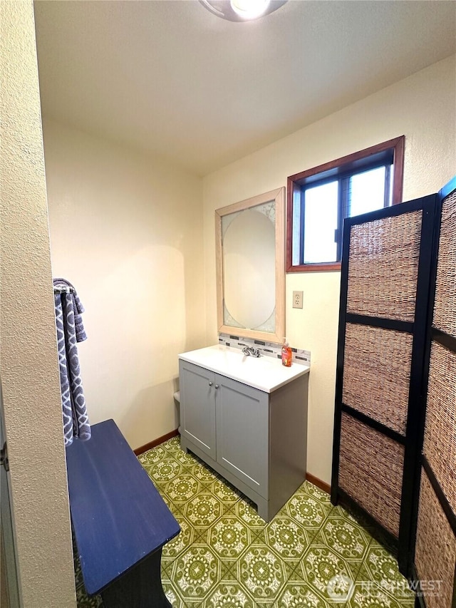 bathroom with vanity and baseboards