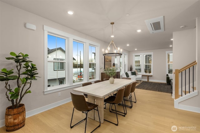 dining room featuring visible vents, baseboards, light wood-style flooring, stairs, and recessed lighting