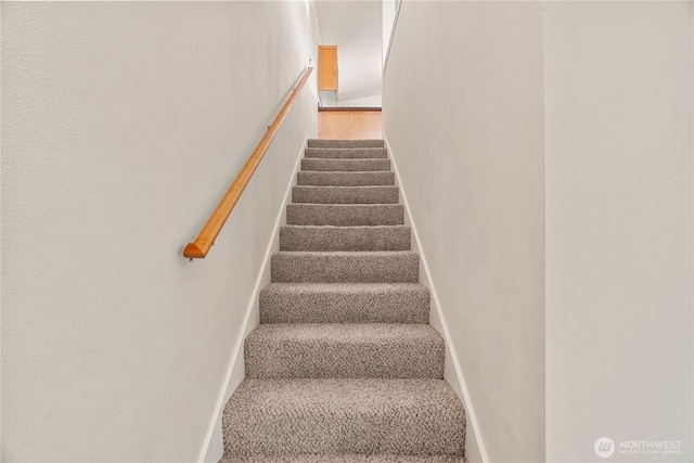 staircase featuring baseboards