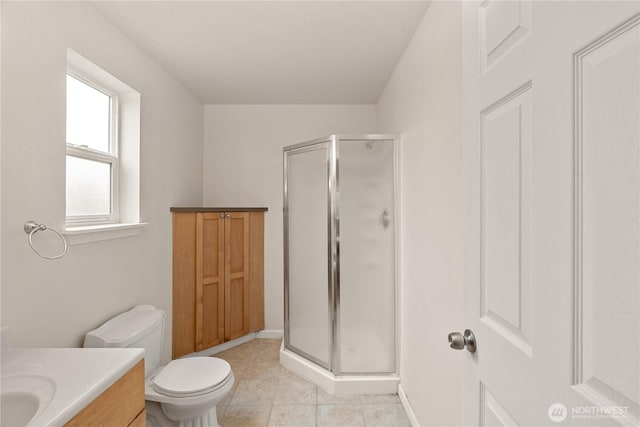 full bath with tile patterned flooring, a shower stall, vanity, and toilet