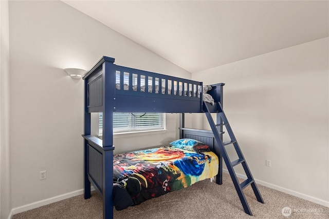 bedroom with carpet floors, baseboards, and vaulted ceiling