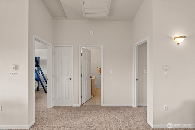 hall with carpet flooring and baseboards