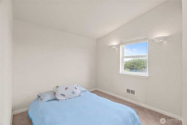 bedroom featuring lofted ceiling, carpet flooring, baseboards, and visible vents