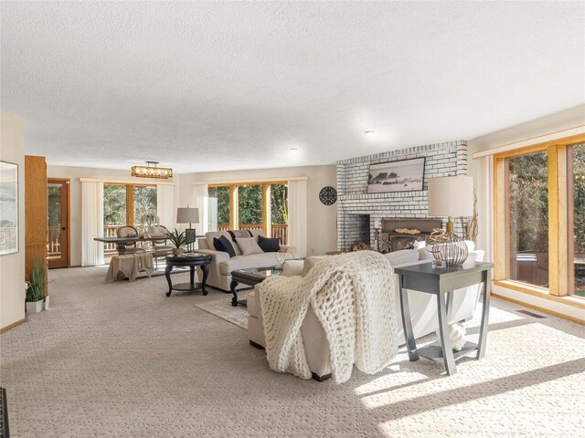 living room featuring carpet, a brick fireplace, and a textured ceiling