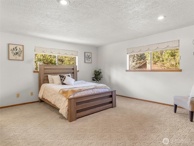 bedroom with baseboards, multiple windows, and carpet flooring