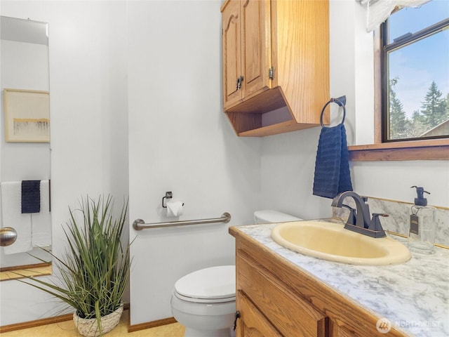 bathroom featuring toilet and vanity