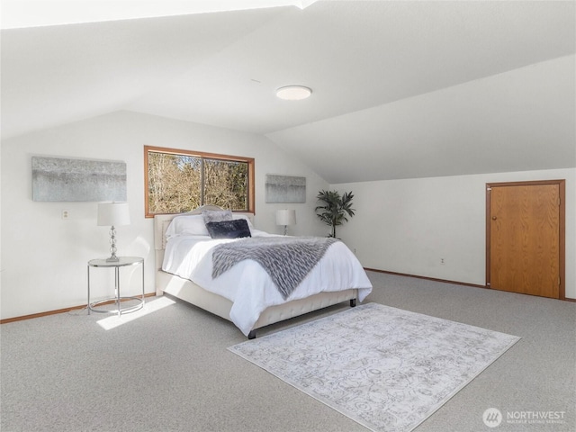 bedroom featuring baseboards, lofted ceiling, and carpet flooring