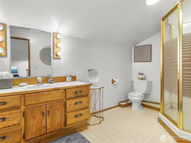 bathroom featuring vanity, baseboards, a shower stall, vaulted ceiling, and toilet