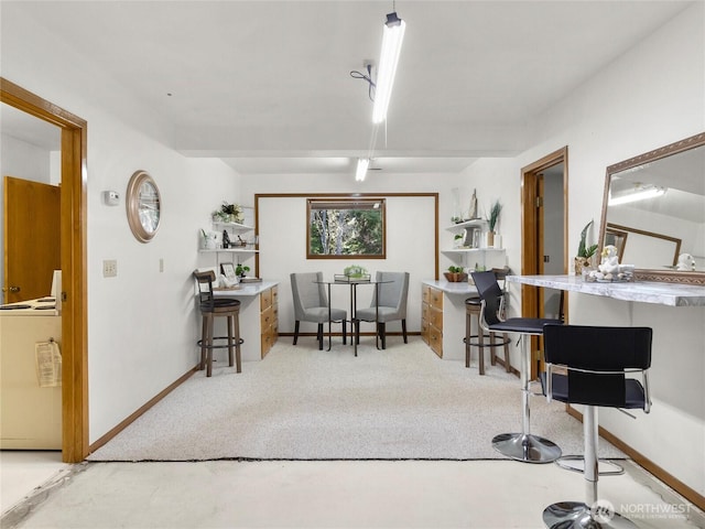 dining room with baseboards and carpet