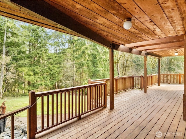 wooden deck with a wooded view