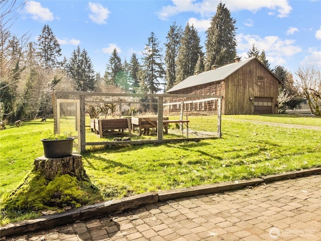 view of yard with an outbuilding and a garage