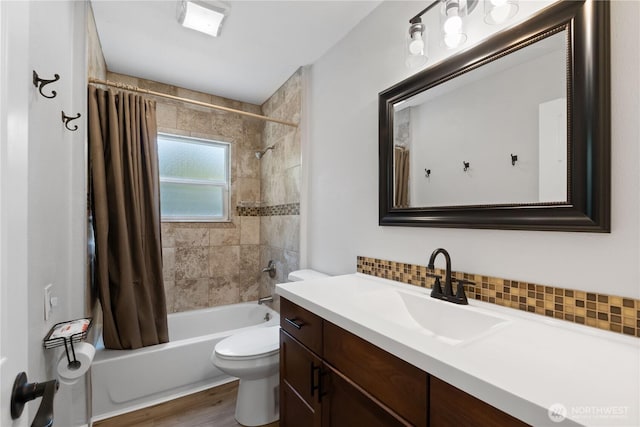 full bath featuring tasteful backsplash, toilet, wood finished floors, shower / bath combination with curtain, and vanity