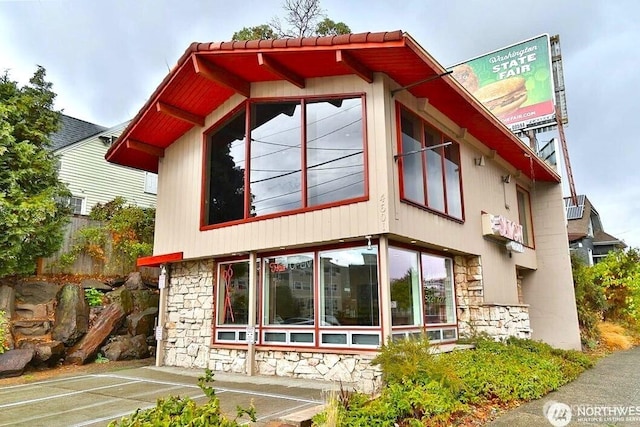 view of side of property with stone siding