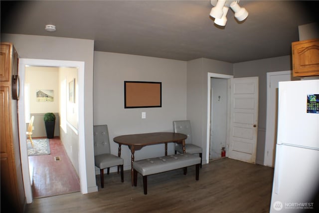 dining area with wood finished floors