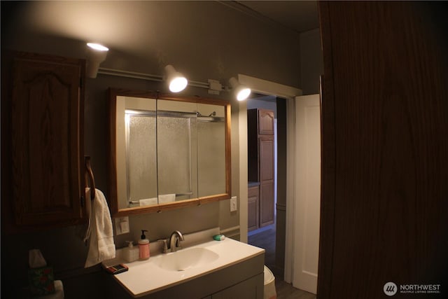 full bath with vanity and an enclosed shower