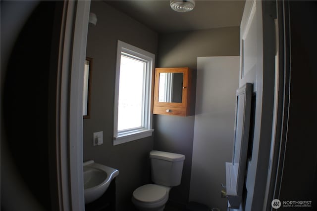 bathroom with toilet and a sink