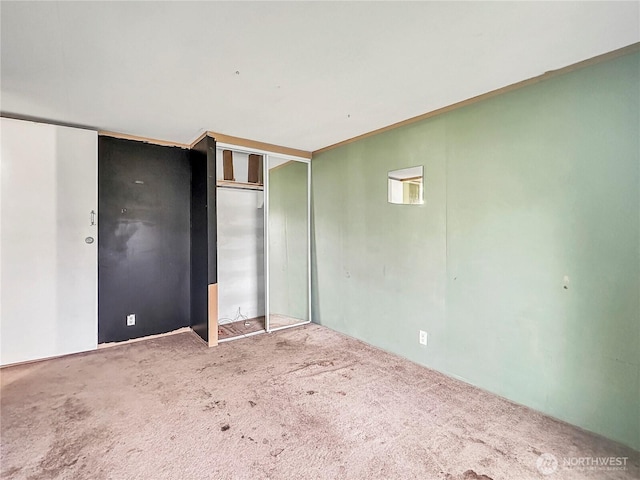 unfurnished bedroom featuring a closet and carpet floors