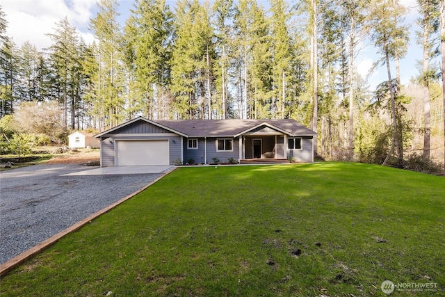 ranch-style house featuring a garage, gravel driveway, and a front yard