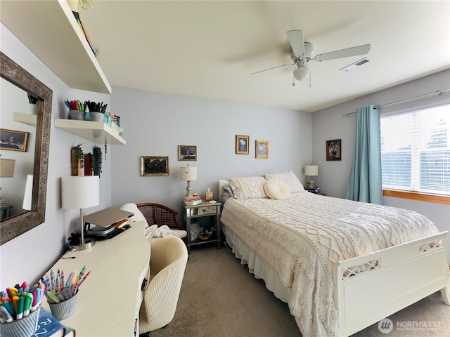carpeted bedroom with visible vents and a ceiling fan