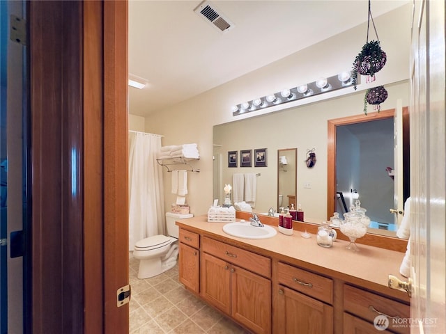 bathroom featuring visible vents, toilet, vanity, and tile patterned flooring