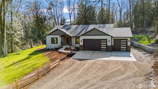 view of front of house with fence, dirt driveway, a front yard, a garage, and stone siding