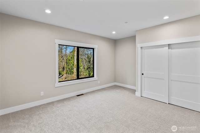 unfurnished bedroom featuring recessed lighting, baseboards, and carpet